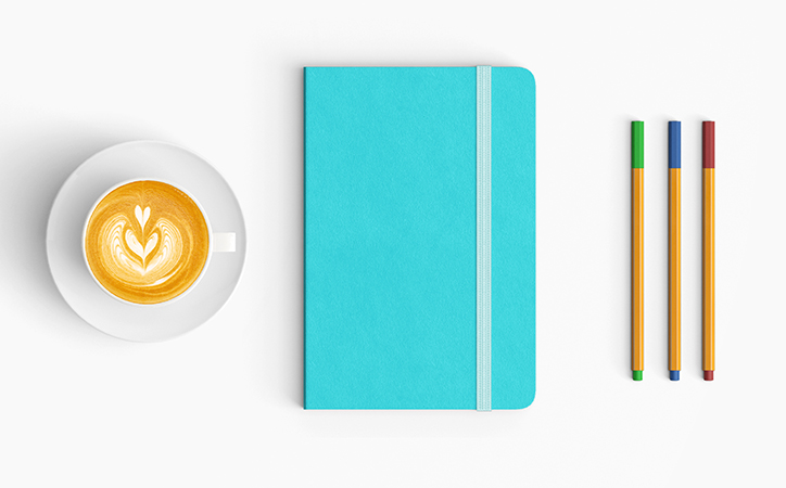 blue notebook and latte